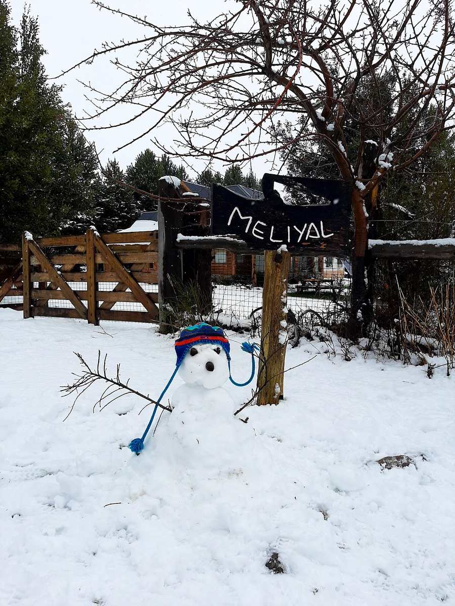 El cartel de Cabañas Meliyal con nieve y un muñeco de nieve